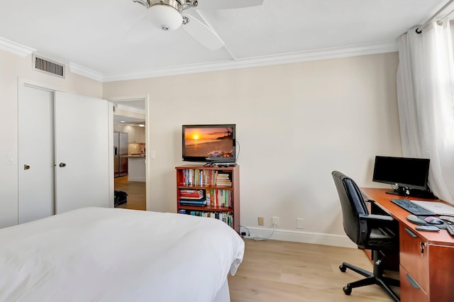 bedroom featuring light hardwood / wood-style flooring, ornamental molding, and stainless steel refrigerator with ice dispenser