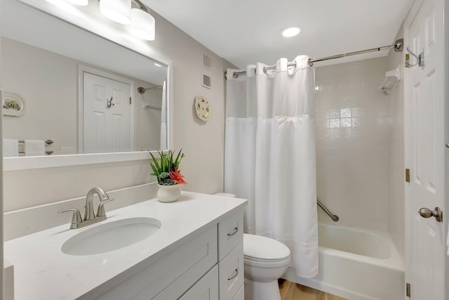 full bathroom featuring shower / tub combo, vanity, and toilet