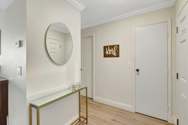 entrance foyer with ornamental molding and light wood-type flooring