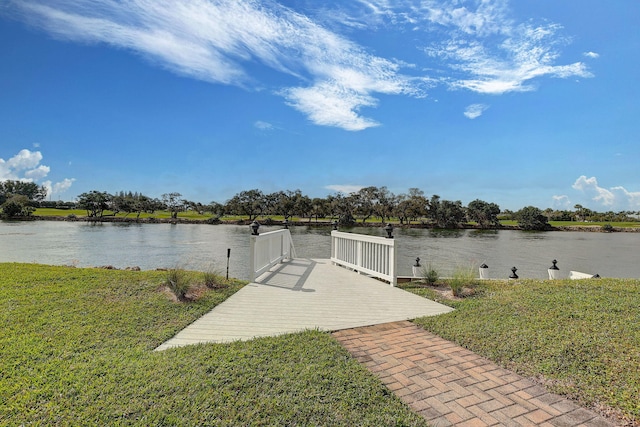 dock area with a water view and a lawn