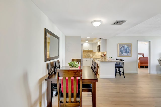 dining area with light hardwood / wood-style flooring