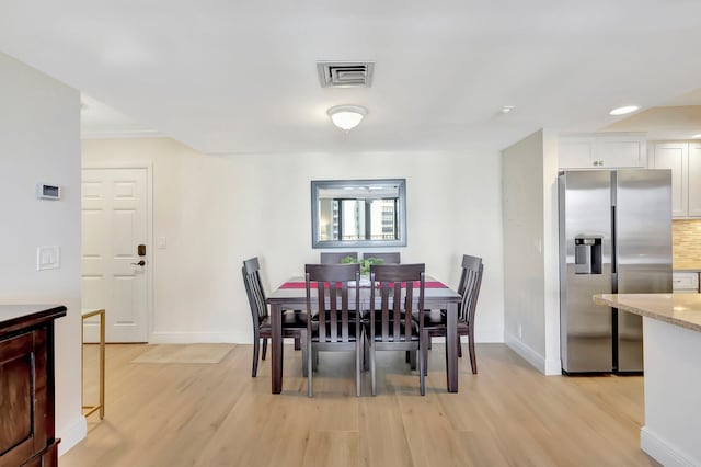 dining area featuring light wood-type flooring