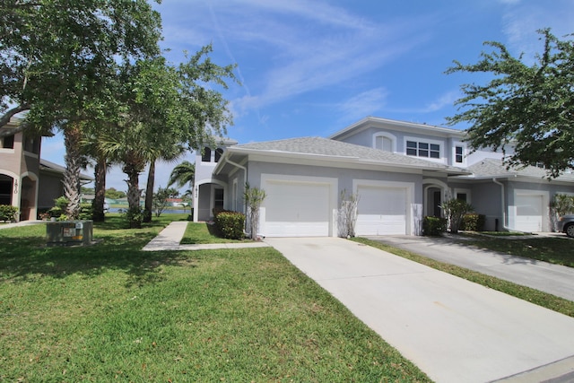 view of front of house with a garage and a front lawn