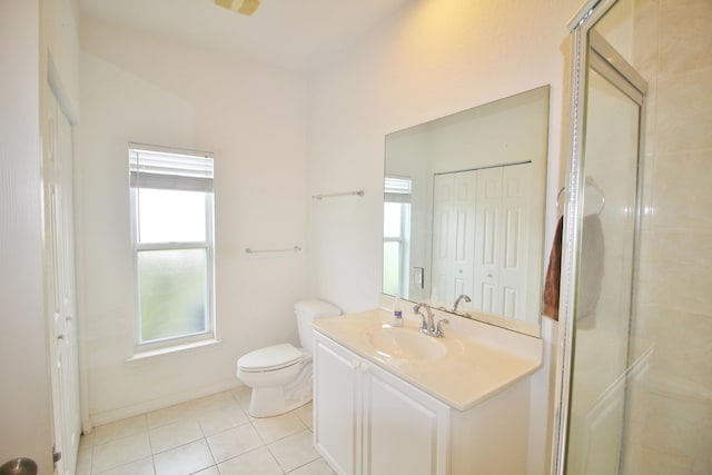 bathroom featuring tile patterned flooring, vanity, a shower with shower door, and toilet