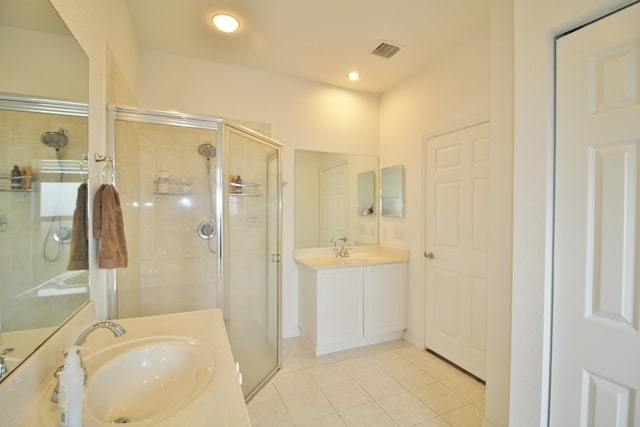 bathroom with vanity, an enclosed shower, and tile patterned flooring