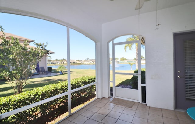 sunroom / solarium with a water view and plenty of natural light