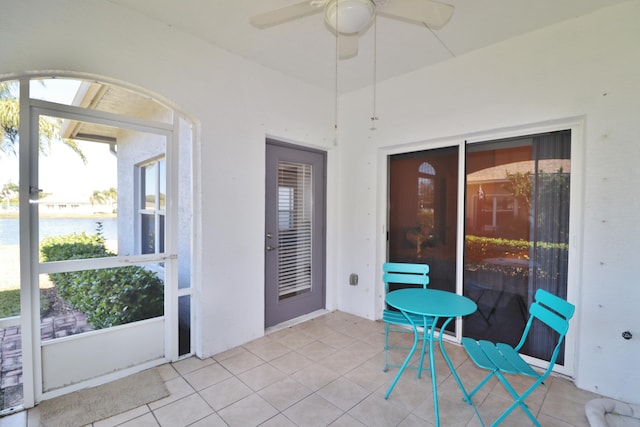 unfurnished sunroom featuring ceiling fan