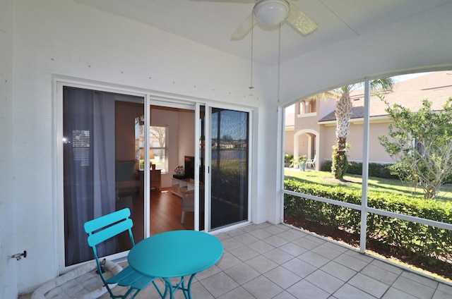 sunroom / solarium featuring ceiling fan