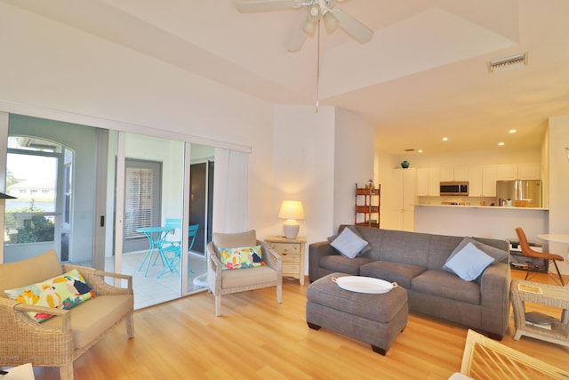 living room featuring ceiling fan and light hardwood / wood-style floors