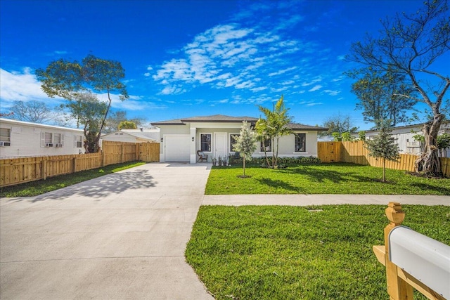 ranch-style home with a garage and a front lawn