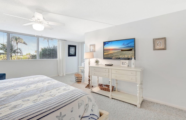 bedroom featuring light carpet and ceiling fan