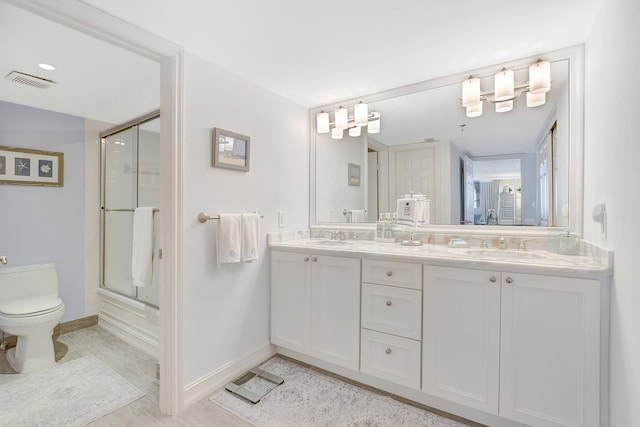 full bathroom with enclosed tub / shower combo, vanity, toilet, and tile patterned floors