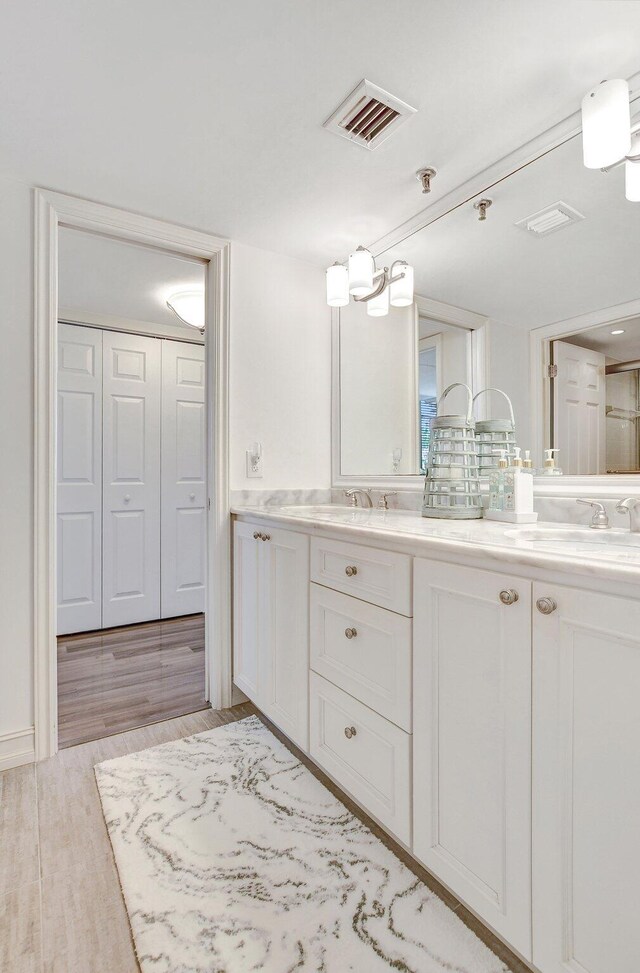 bathroom featuring tasteful backsplash, vanity, and hardwood / wood-style floors