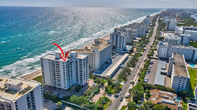 bird's eye view with a water view and a beach view