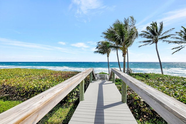 surrounding community with a beach view and a water view