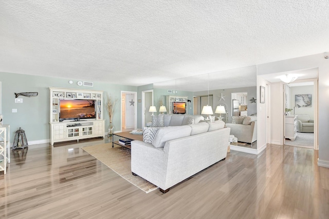 living room featuring hardwood / wood-style flooring and a textured ceiling