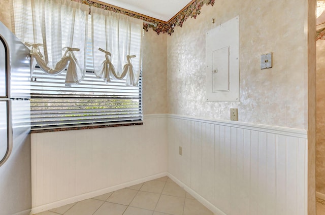 tiled spare room with electric panel