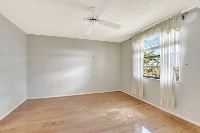 spare room featuring ceiling fan, a textured ceiling, and light hardwood / wood-style floors