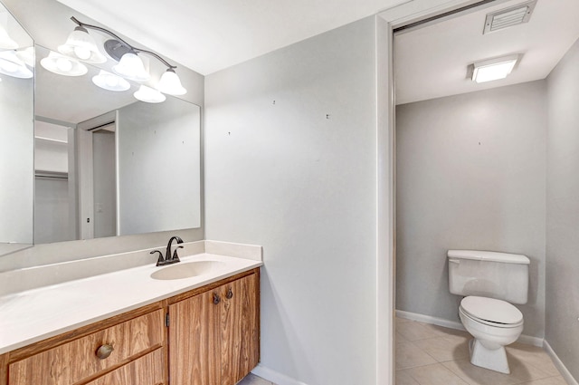 bathroom featuring vanity, tile patterned floors, and toilet