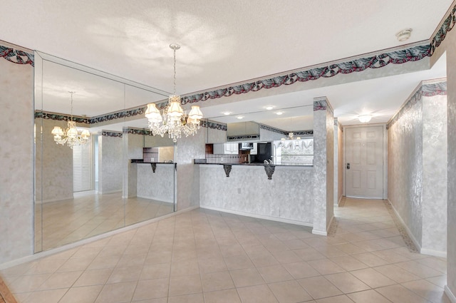 interior space featuring light tile patterned floors and a notable chandelier