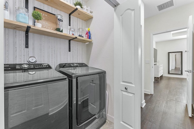 washroom with washer and clothes dryer and hardwood / wood-style floors