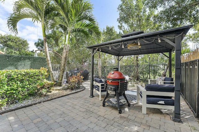 view of patio / terrace featuring a gazebo, a grill, and an outdoor hangout area