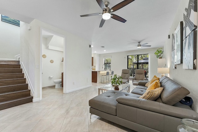 tiled living room featuring sink and ceiling fan