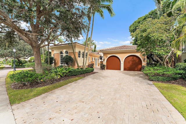 mediterranean / spanish house featuring a garage