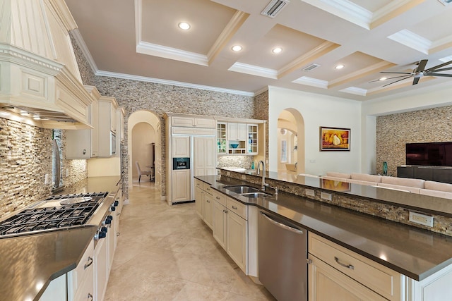 kitchen featuring appliances with stainless steel finishes, sink, backsplash, coffered ceiling, and cream cabinets