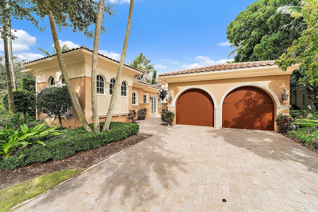 mediterranean / spanish house featuring a garage