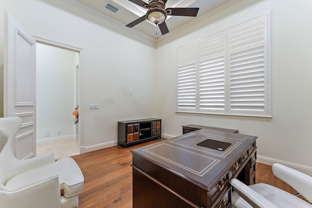 office space with crown molding, ceiling fan, and light hardwood / wood-style flooring