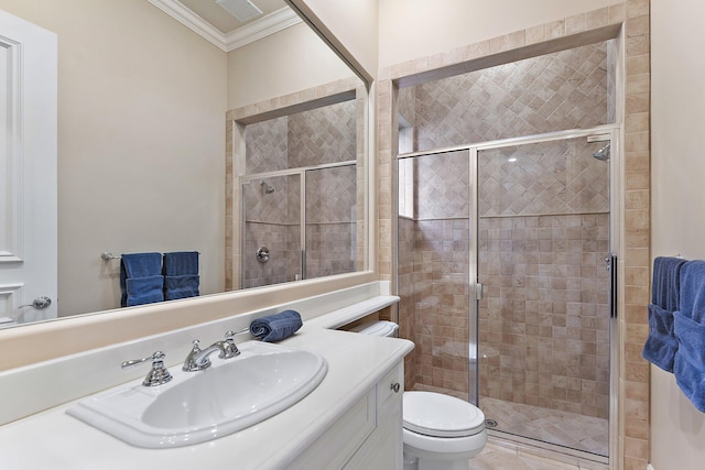 bathroom featuring a shower with door, crown molding, vanity, and toilet