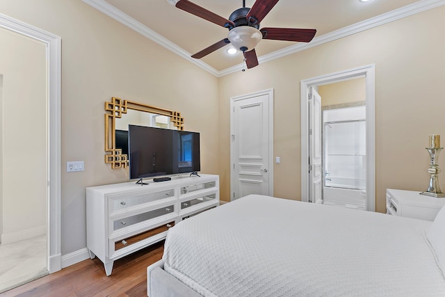 bedroom with crown molding, ceiling fan, connected bathroom, and hardwood / wood-style flooring