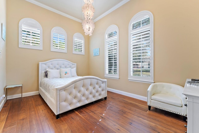 bedroom with ornamental molding, a chandelier, hardwood / wood-style floors, and multiple windows