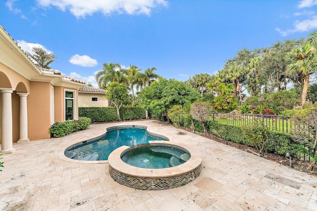 view of swimming pool with an in ground hot tub and a patio