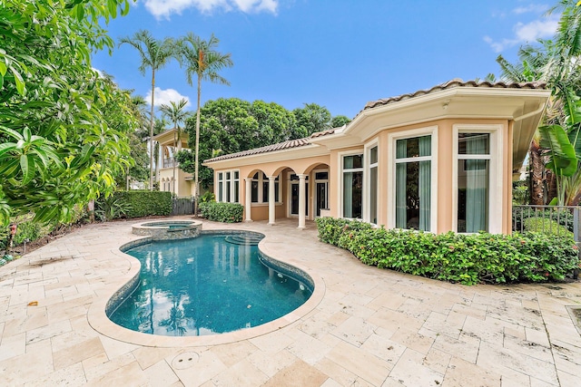 view of pool featuring an in ground hot tub and a patio area