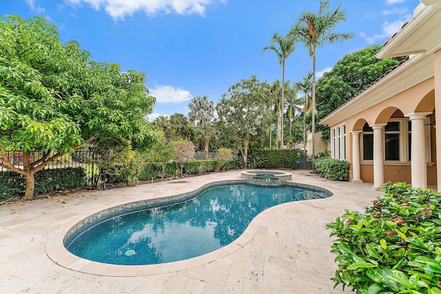 view of pool with an in ground hot tub and a patio