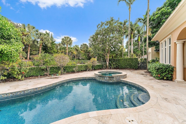 view of pool with a patio and an in ground hot tub