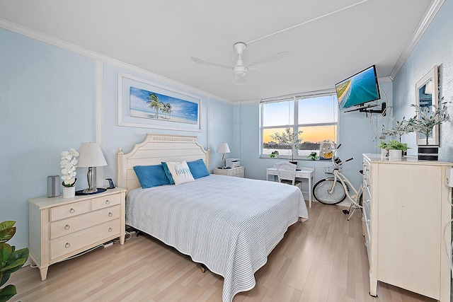 bedroom with light wood finished floors, crown molding, and a ceiling fan