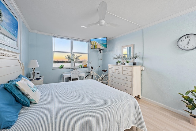 bedroom featuring light hardwood / wood-style flooring, ornamental molding, and ceiling fan