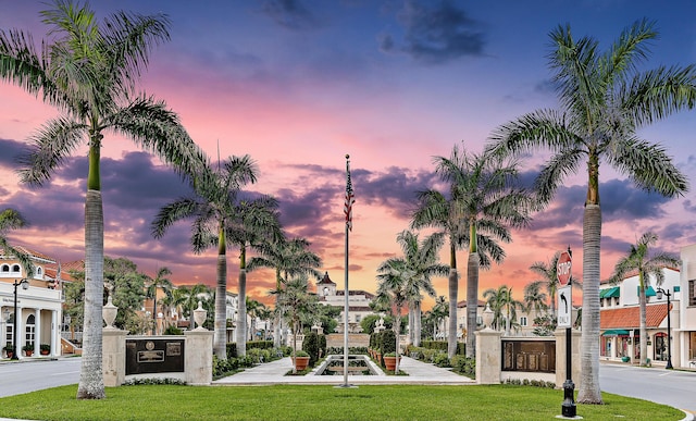 view of property's community with a residential view and a lawn