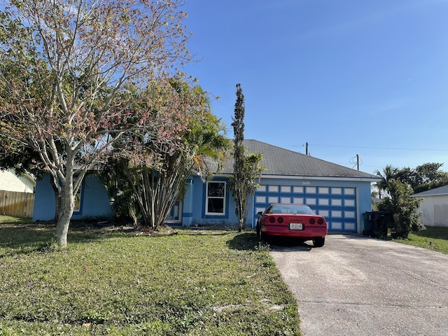 view of front of home with a garage and a front lawn