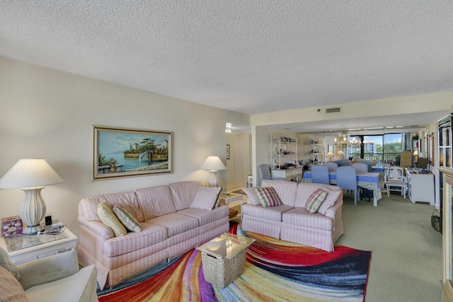 carpeted living room featuring a textured ceiling