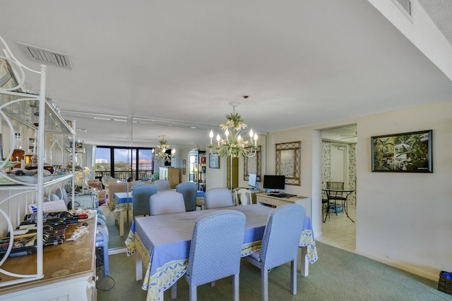 dining area with light colored carpet and a chandelier