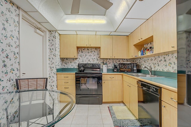 kitchen with light brown cabinetry, sink, light tile patterned floors, ceiling fan, and black appliances