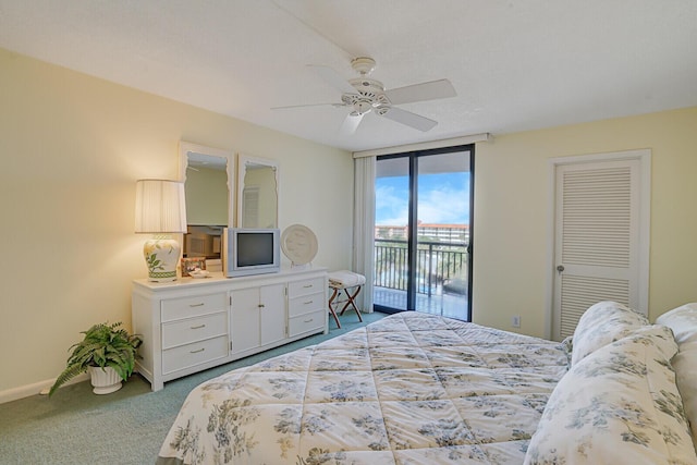 bedroom with ceiling fan, a wall of windows, carpet, and access to outside