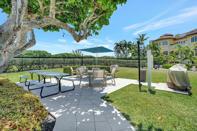 view of community featuring a yard and a patio area