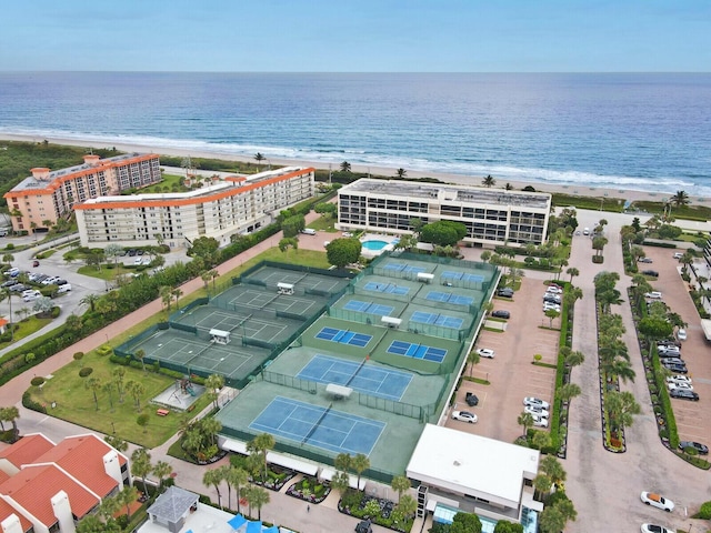 drone / aerial view featuring a water view and a beach view