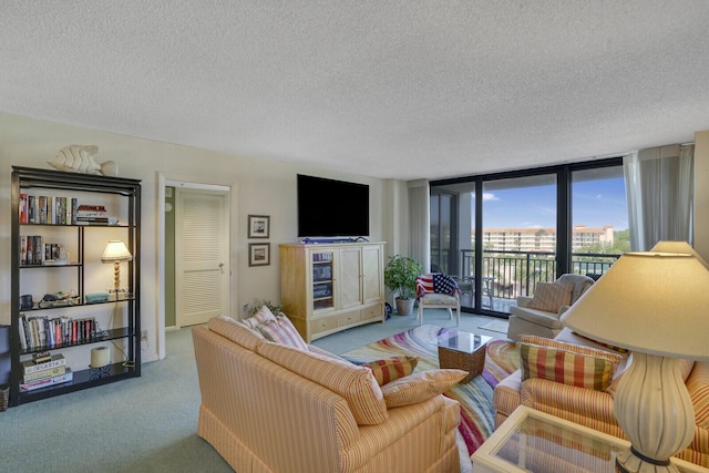 carpeted living room with a wall of windows and a textured ceiling