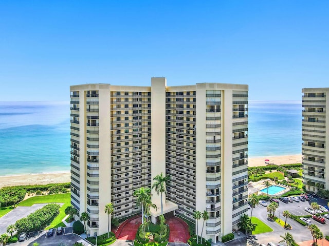 view of property with a beach view and a water view